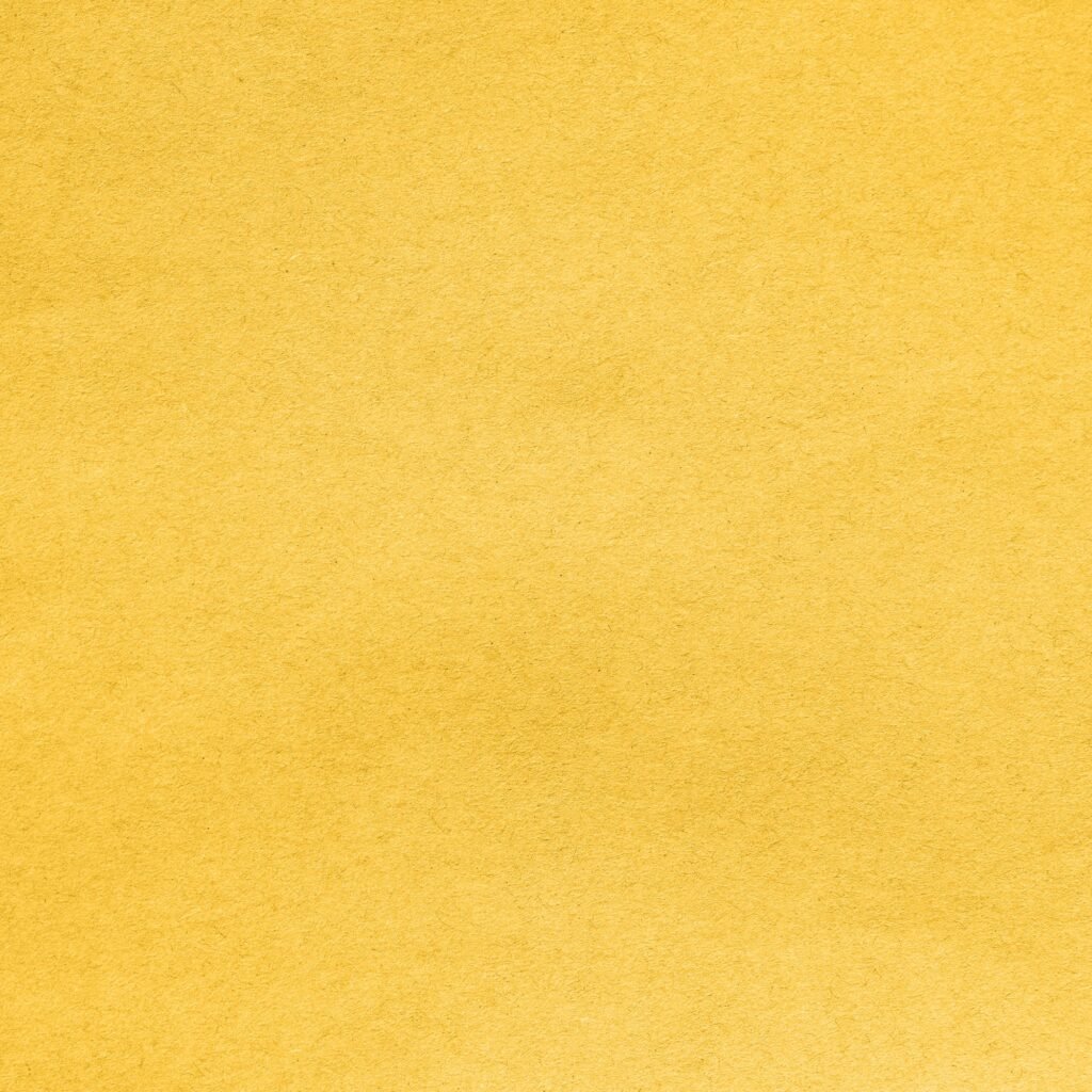Background From Sheet of Recycled Carton Coloring in Trend Fortuna Gold Color. Cardboard Pattern